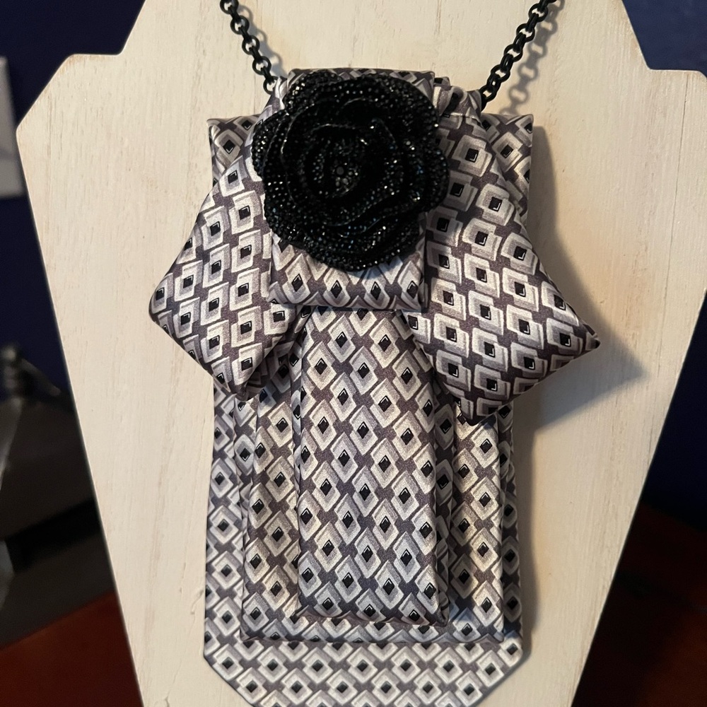 TIE NECKLACE with geometric black, silver and taupe pattern.